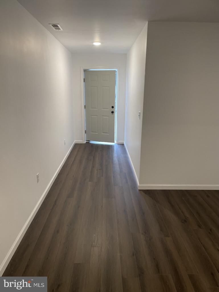 300 Collins Avenue, Unit 3 Hurlock, MD 21643 - Photo 4 of 13 a view of an empty room with wooden floor and a window