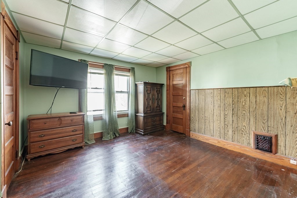 27 Freeman Terrace Springfield, MA 01104 - Photo 17 of 32 an empty room with wooden floor and windows