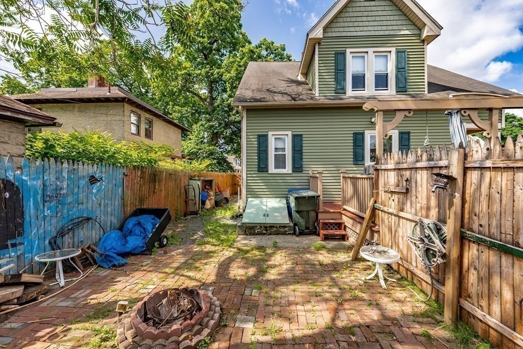 27 Freeman Terrace Springfield, MA 01104 - Photo 28 of 32 a view of backyard with a table and chairs under an umbrella