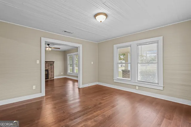 wooden floor in an empty room with a window