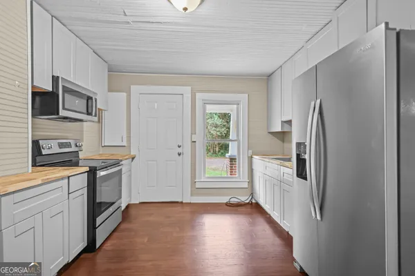 a kitchen with stainless steel appliances granite countertop a refrigerator and a stove top oven