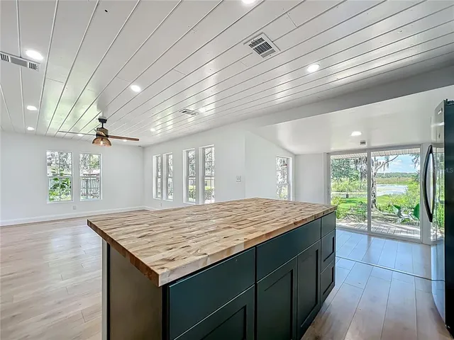 a kitchen with a stove and large window