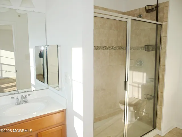 a bathroom with a shower and a sink