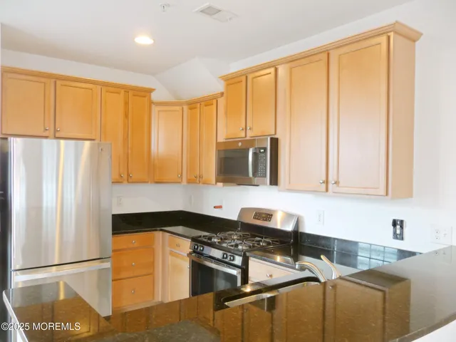 a kitchen with appliances cabinets and a sink