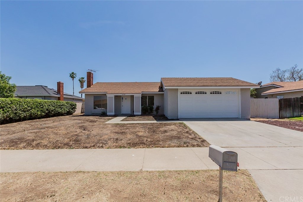 25187 Sugar Hill Road Moreno Valley, CA 92553 - Photo 1 of 1 a front view of a house with a yard and a garage