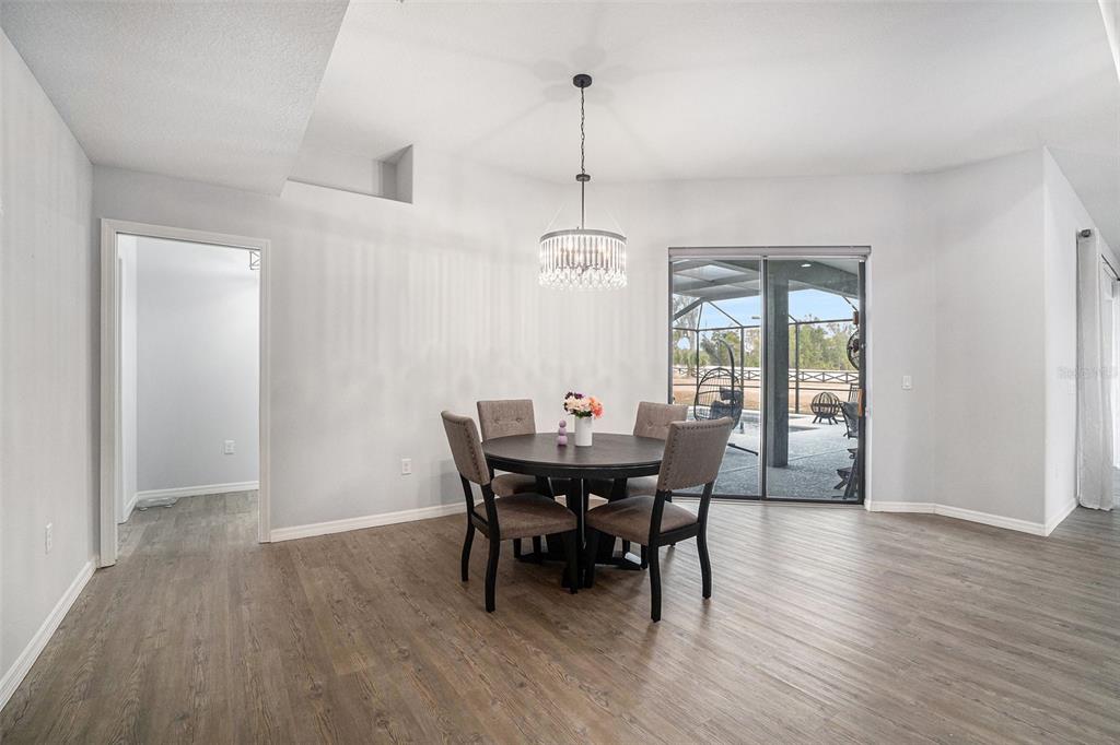7403 Northeast 22nd Ct Road Ocala, FL 34479 - Photo 11 of 37 a view of a dining room with furniture window and wooden floor