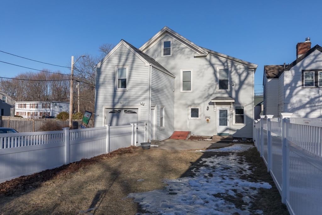 215 Central Street Saugus, MA 01906 - Photo 33 of 41 a view of a white house with iron fence
