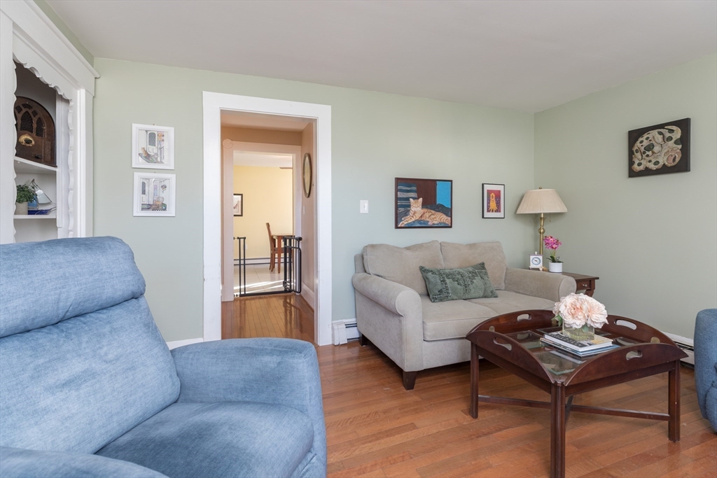 215 Central Street Saugus, MA 01906 - Photo 5 of 41 a living room with furniture and a dining table with wooden floor