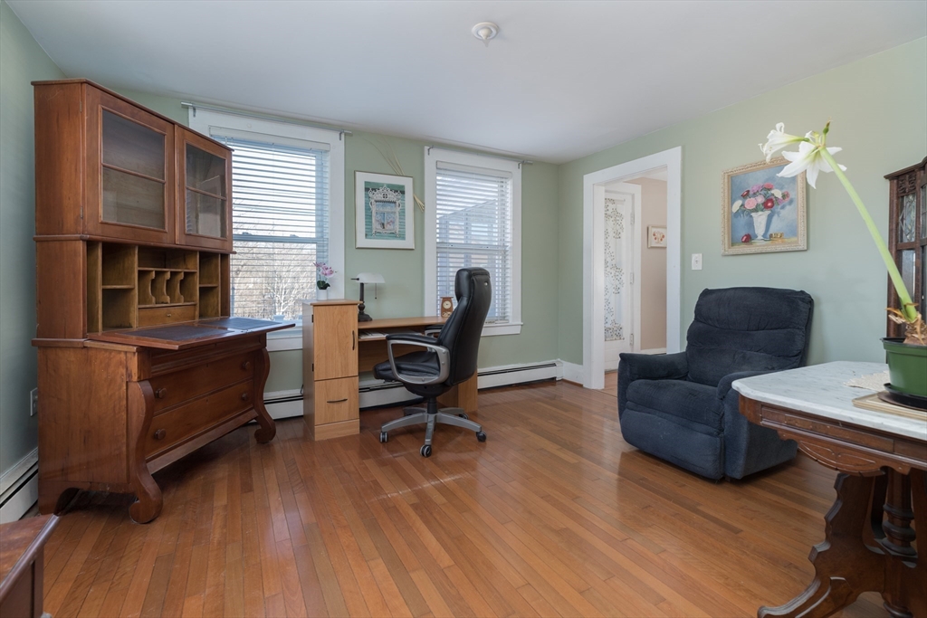 215 Central Street Saugus, MA 01906 - Photo 7 of 41 a living room with furniture a desk and chair with wooden floor