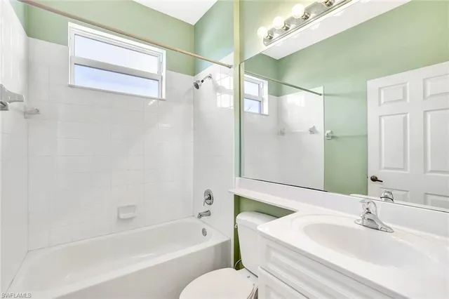 a bathroom with a sink mirror toilet and bathtub