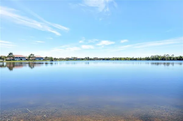 a view of a lake view with houses in the back