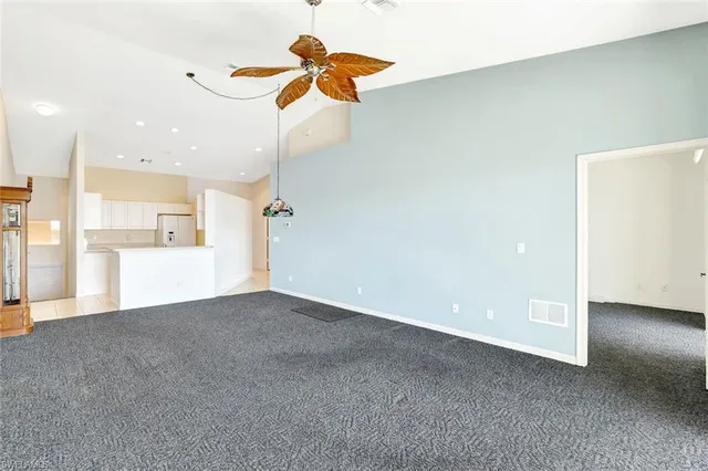 a view of a kitchen with a sink and a refrigerator