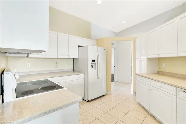 a kitchen with a cabinets and white appliances