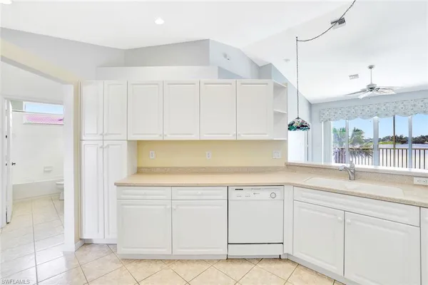 a kitchen with white cabinets