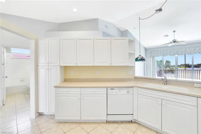a kitchen with white cabinets