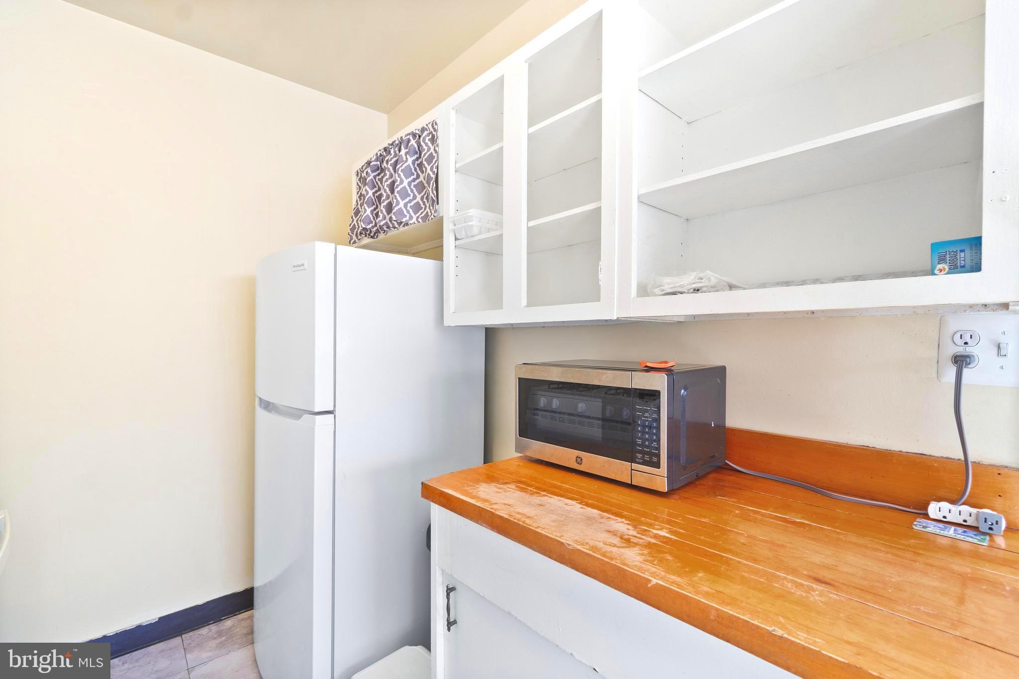 8601 Manchester Road, Unit 513 Silver Spring, MD 20901 - Photo 12 of 31 a kitchen with a refrigerator and a more cabinets