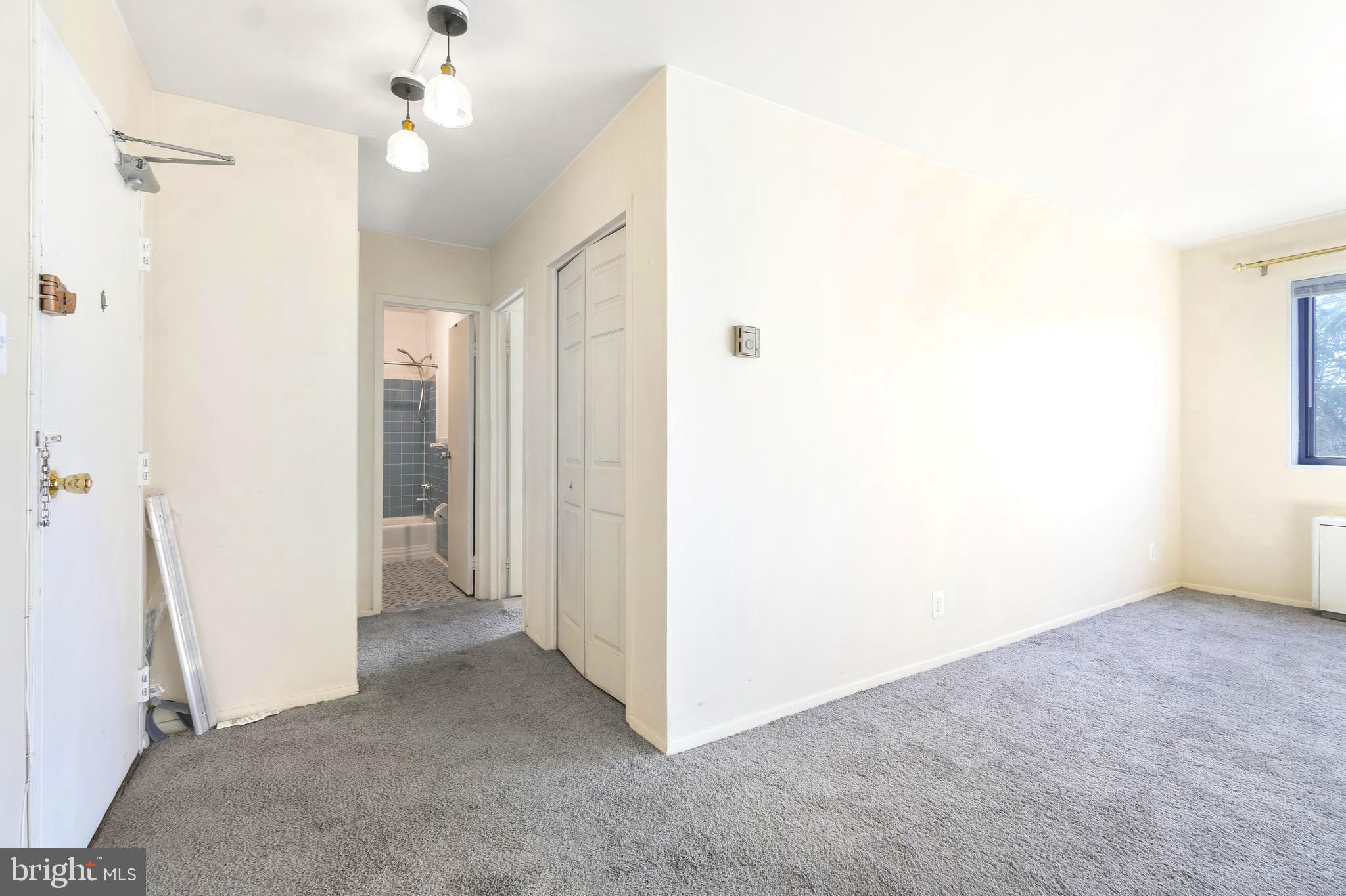 8601 Manchester Road, Unit 513 Silver Spring, MD 20901 - Photo 13 of 31 a view of a big room with windows and chandelier fan