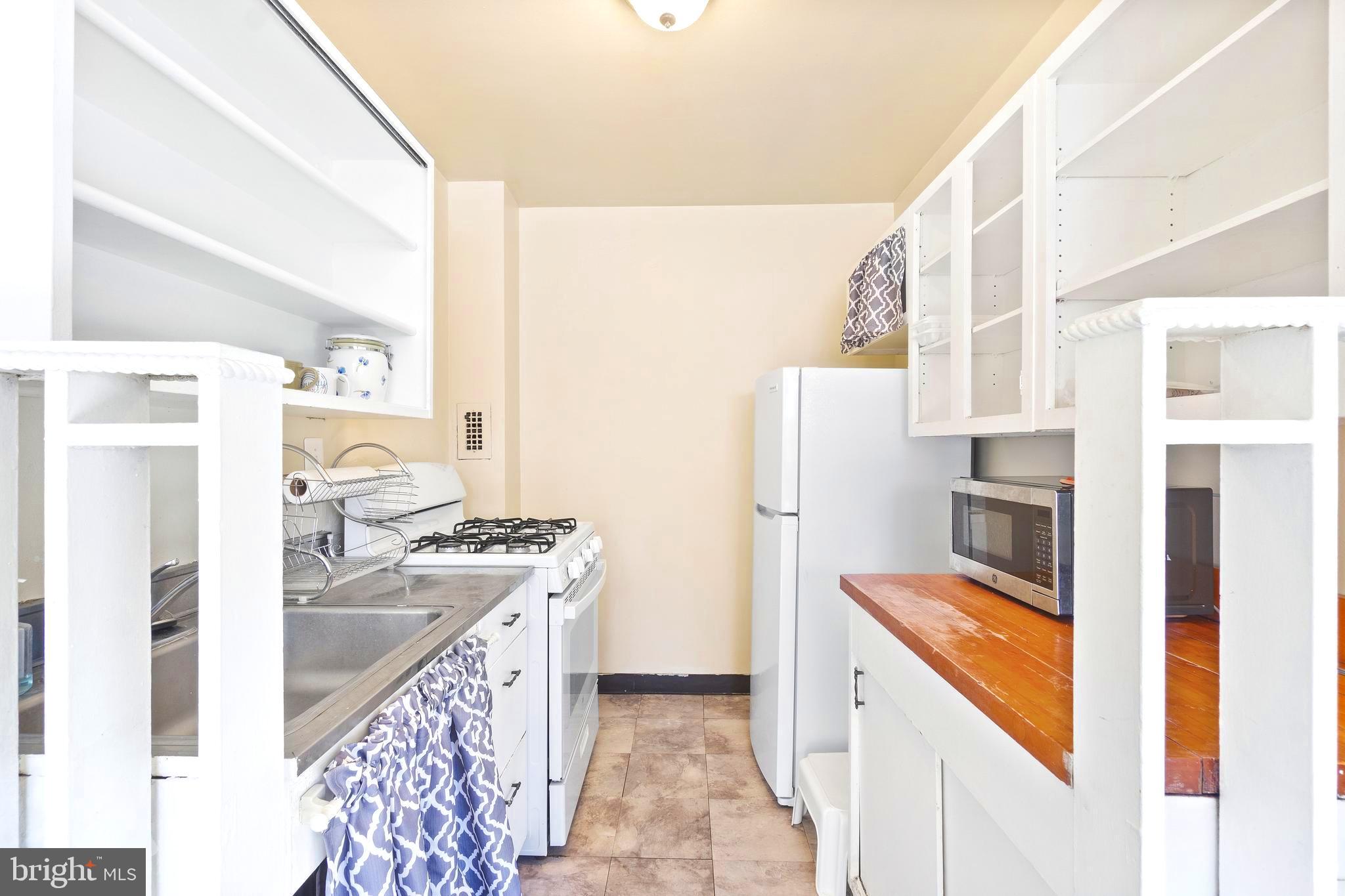 8601 Manchester Road, Unit 513 Silver Spring, MD 20901 - Photo 3 of 31 a kitchen with stainless steel appliances granite countertop a refrigerator a stove and a sink with wooden floor