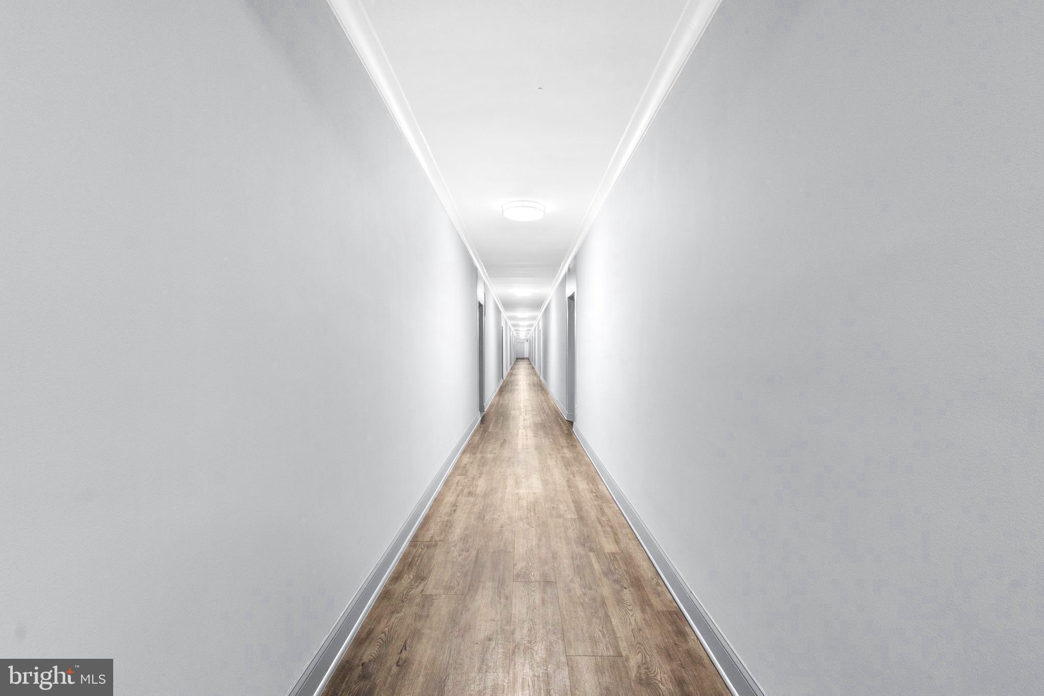 8601 Manchester Road, Unit 513 Silver Spring, MD 20901 - Photo 6 of 31 a view of a hallway with wooden floor