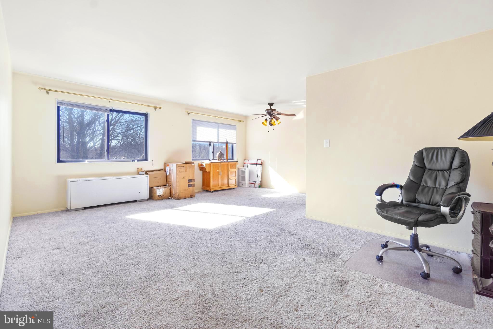 8601 Manchester Road, Unit 513 Silver Spring, MD 20901 - Photo 7 of 31 a living room with furniture and a window