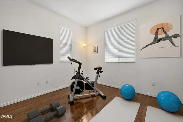 a room with gym equipment and a flat screen tv