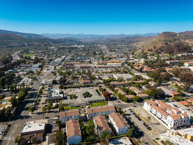 an aerial view of residential houses with city view