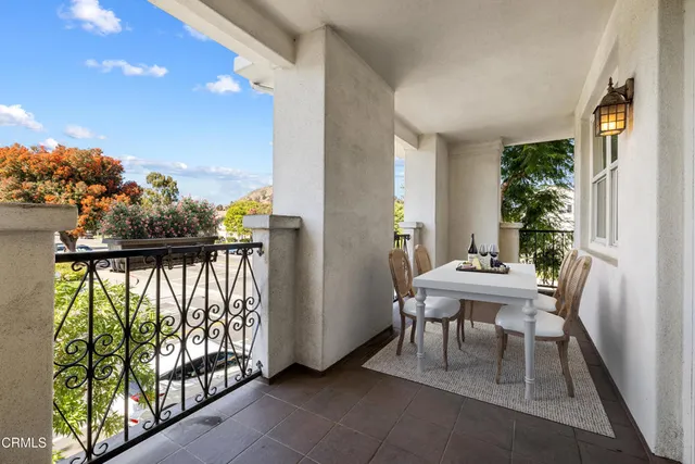 a balcony with table and chairs