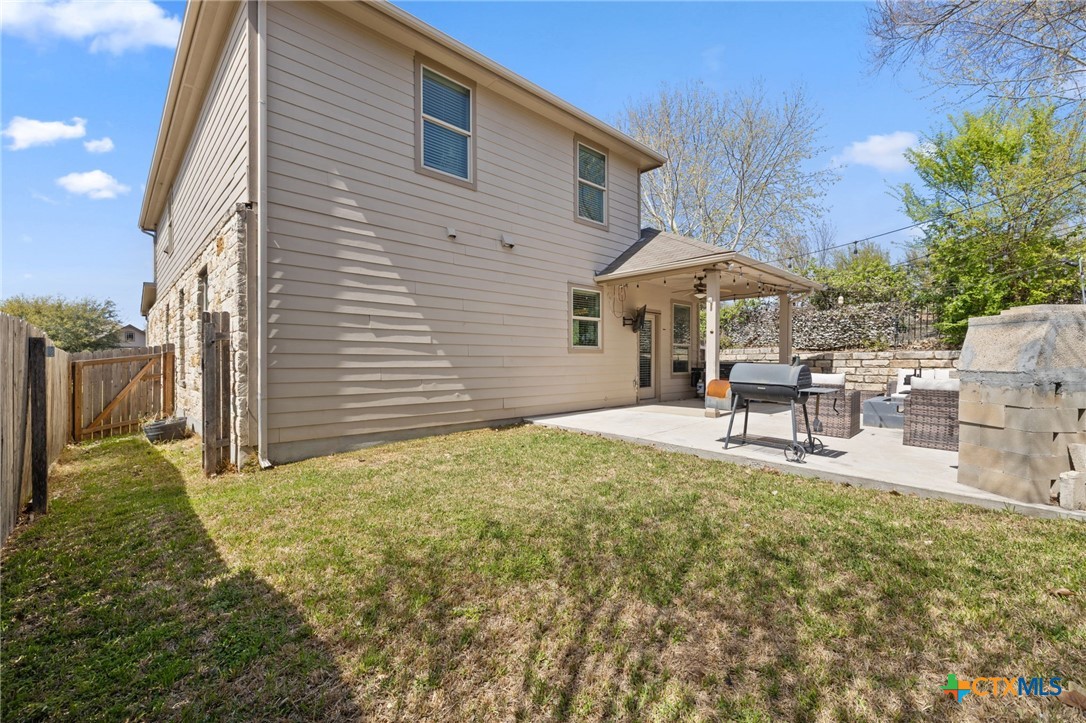 10113 Copper Ridge Cove Austin, TX 78747 - Photo 30 of 32 a backyard of a house with table and chairs