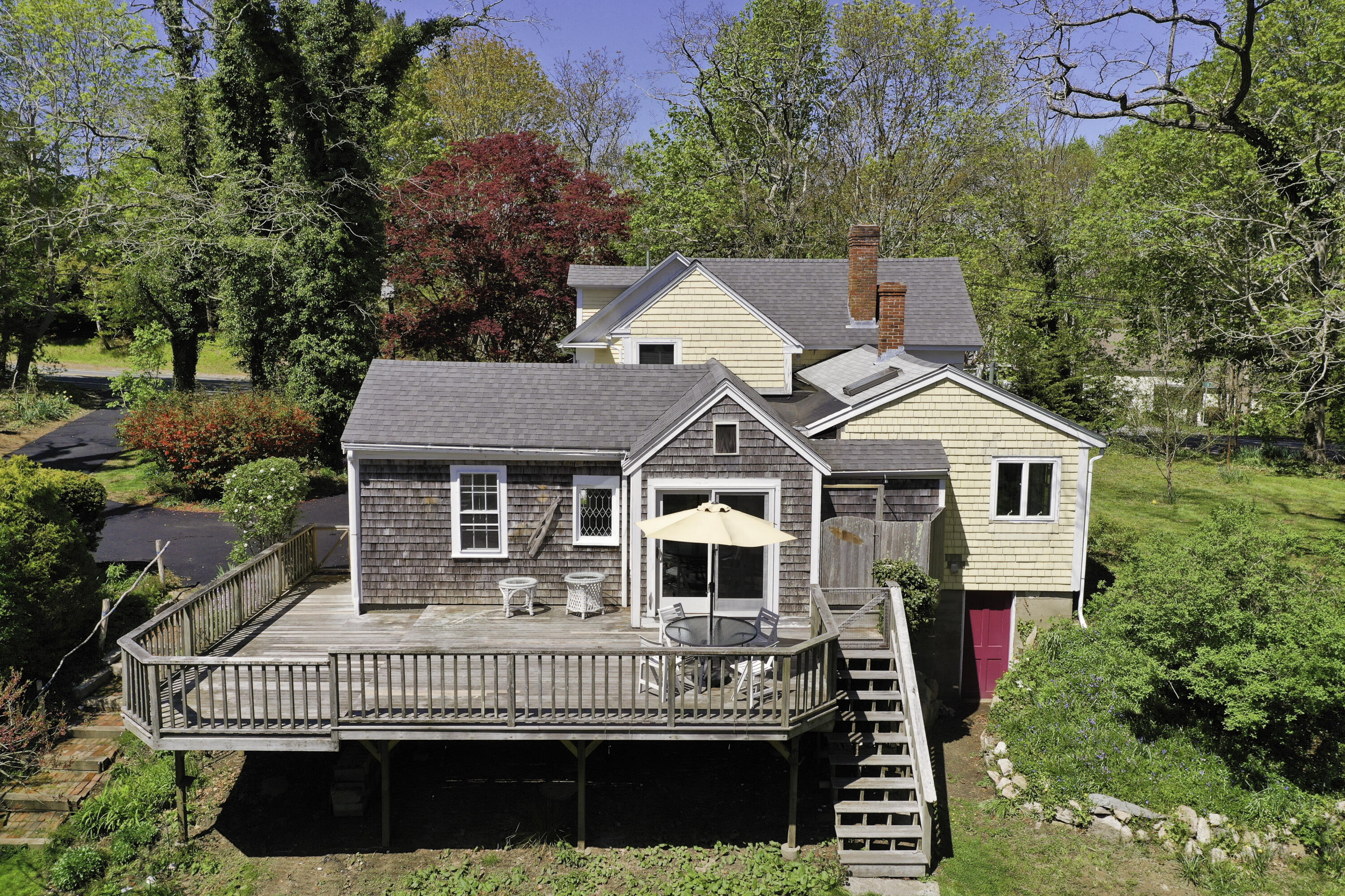 1295 County Road Cataumet, MA 02534 - Photo 14 of 16 a front view of a house with a garden and trees