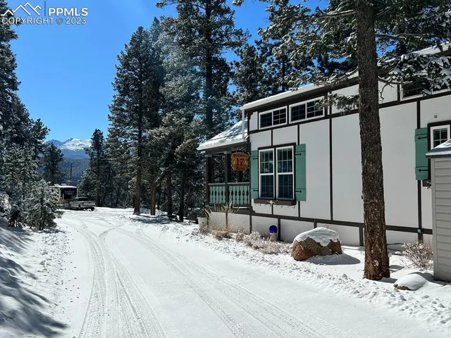 a view of a house with snow on the road