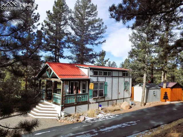 a front view of a house with a yard and tree s