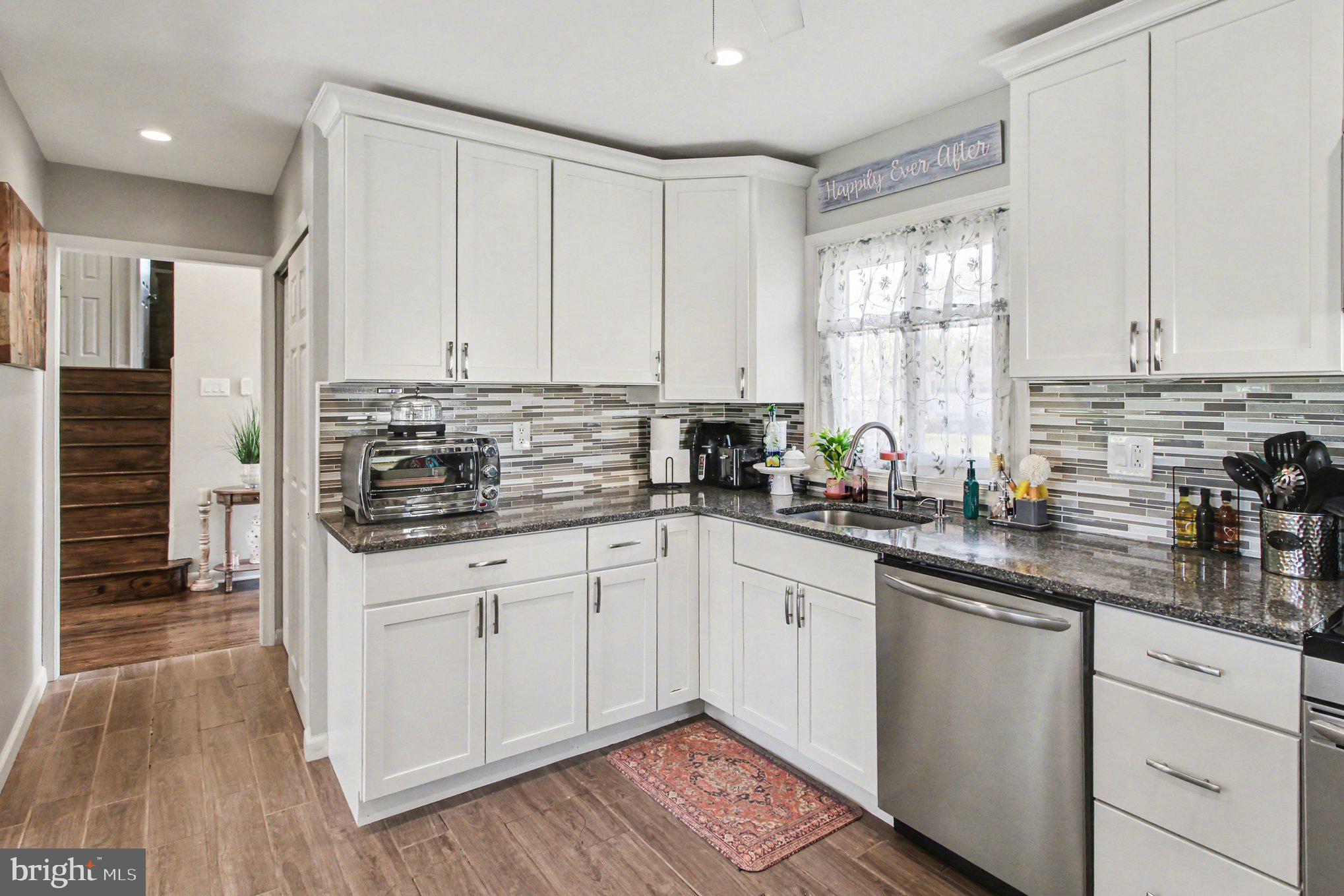 908 Fraser Road Glenside, PA 19038 - Photo 14 of 36 a kitchen with stainless steel appliances granite countertop a stove a sink and white cabinets
