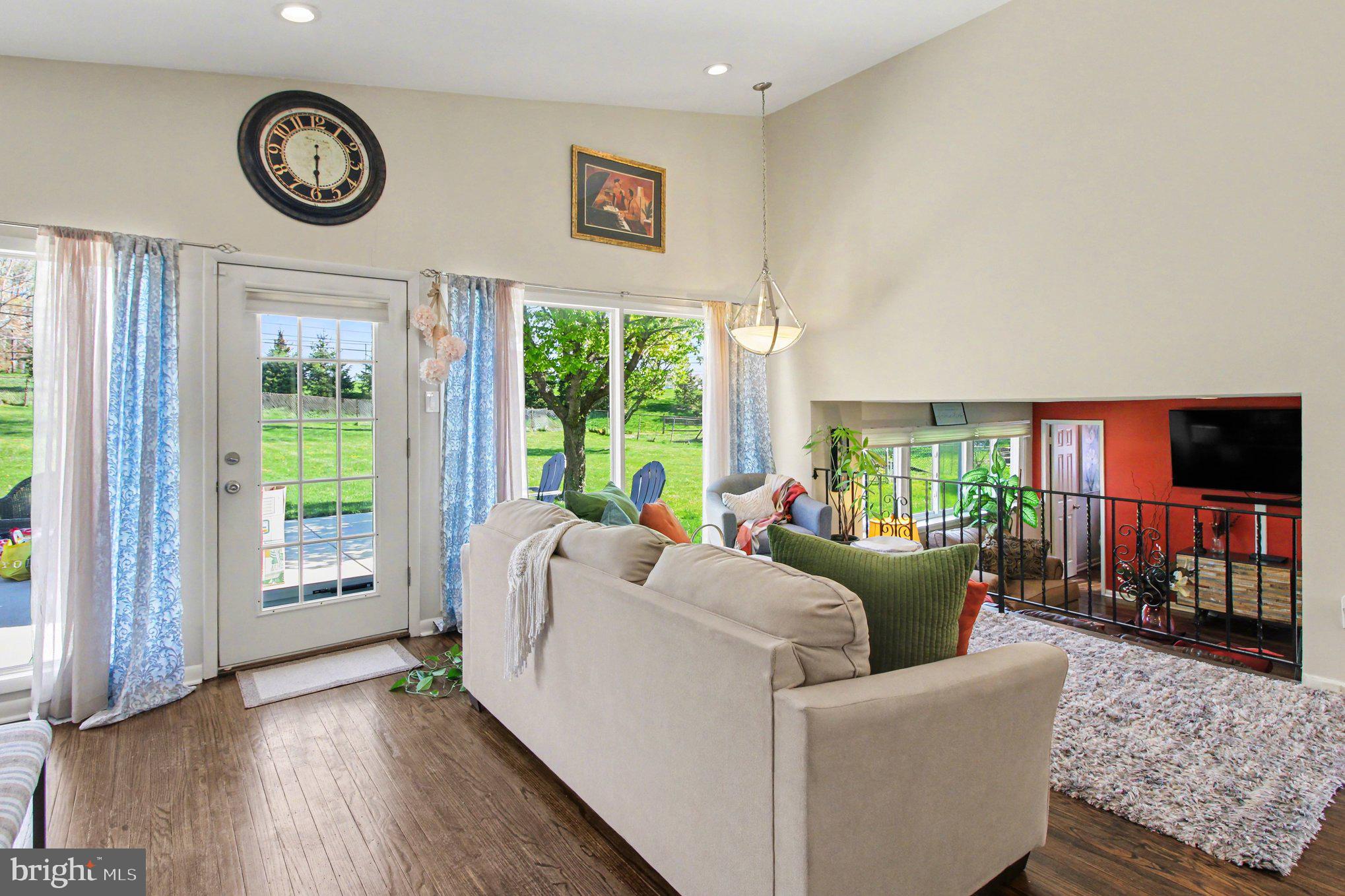 908 Fraser Road Glenside, PA 19038 - Photo 10 of 36 a living room with furniture a window and a clock