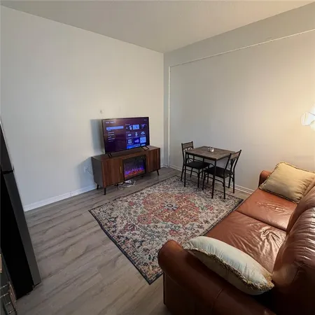 a living room with furniture and a rug