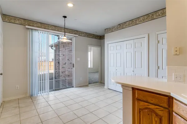 a view of kitchen with granite countertop cabinets and window