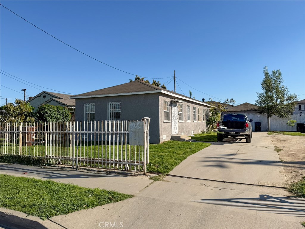 804 East Oaks Street Compton, CA 90221 - Photo 1 of 9 a front view of a house with a garden and plants