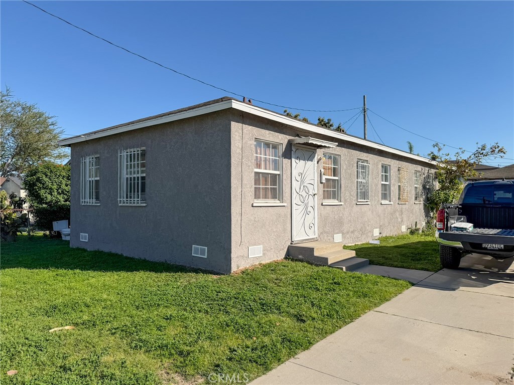 804 East Oaks Street Compton, CA 90221 - Photo 3 of 9 a front view of a house with garden