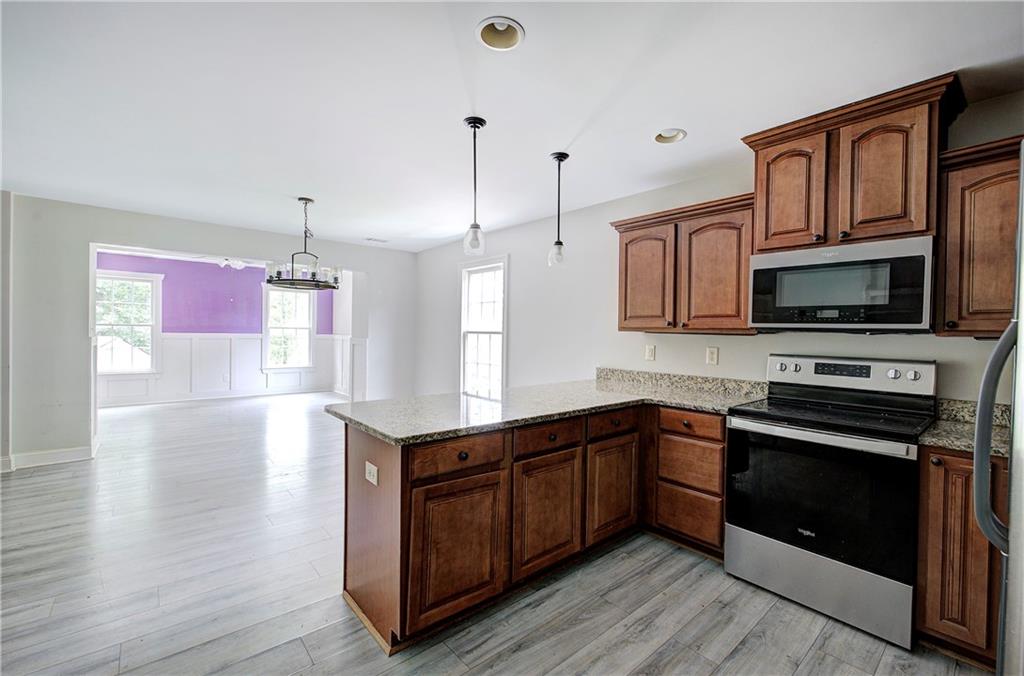 561 Holland Road Dallas, GA 30157 - Photo 14 of 48 a kitchen with stainless steel appliances granite countertop a sink stove and microwave