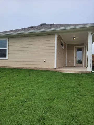a view of a backyard with a wooden fence