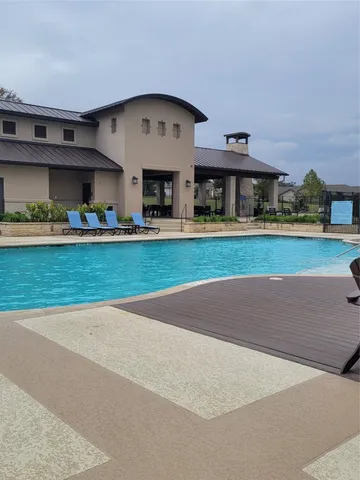 a large building with a big yard and large trees