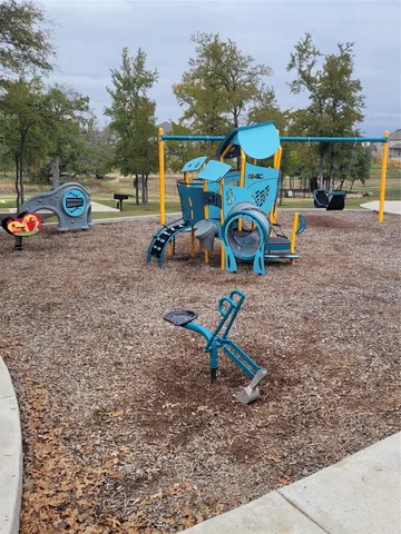 a childrens park with lots of swings and slides