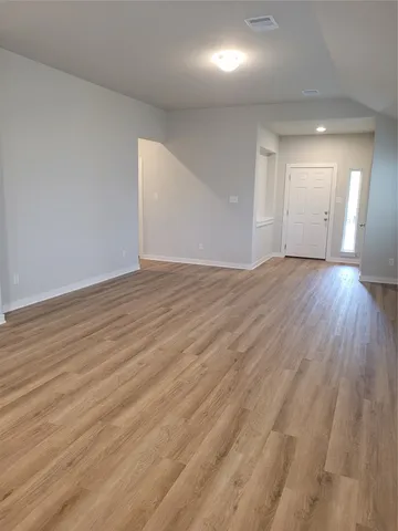 a kitchen with stainless steel appliances a refrigerator a stove a sink and white cabinets