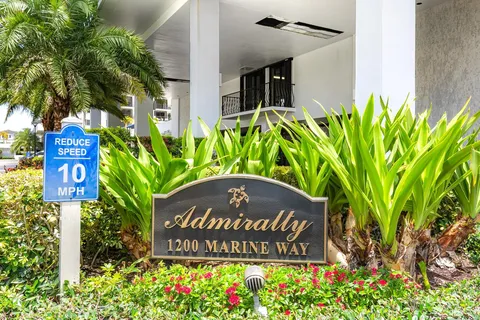 a living room with furniture a bookshelf and a book shelf