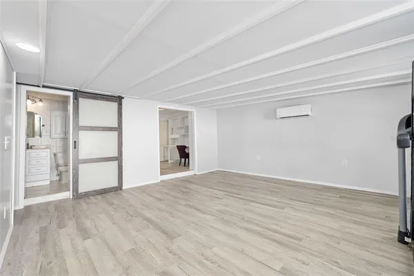 a view of empty room with wooden floor