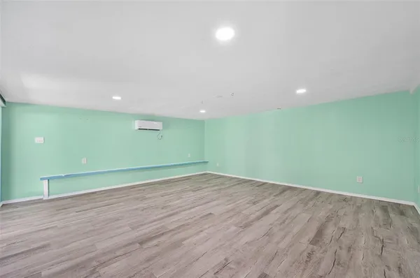 a view of room with wooden floor