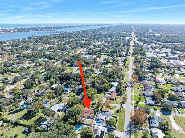 an aerial view of a house with a yard