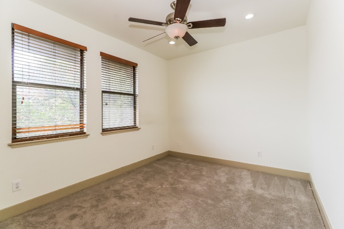 1212 Woodland Avenue, Unit A Austin, TX 78704 - Photo 13 of 20 an empty room with a window and a fan