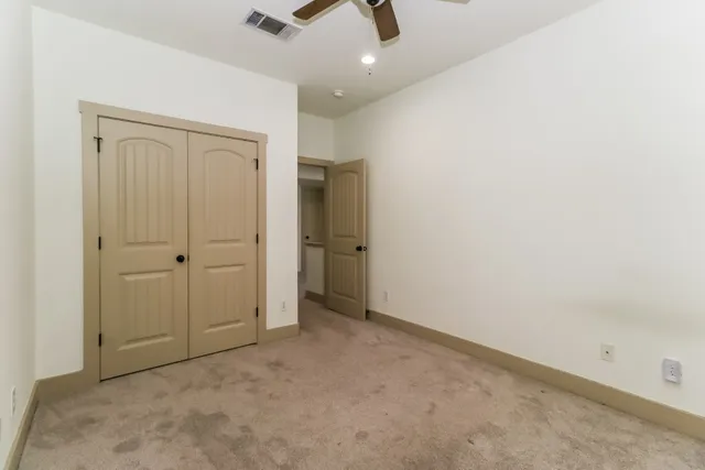 an empty room with closet area