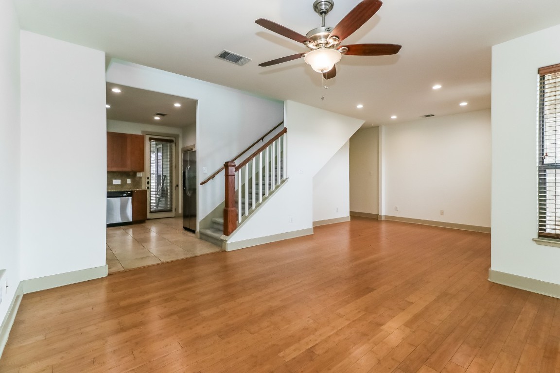 1212 Woodland Avenue, Unit A Austin, TX 78704 - Photo 5 of 20 an empty room with wooden floor fan and windows