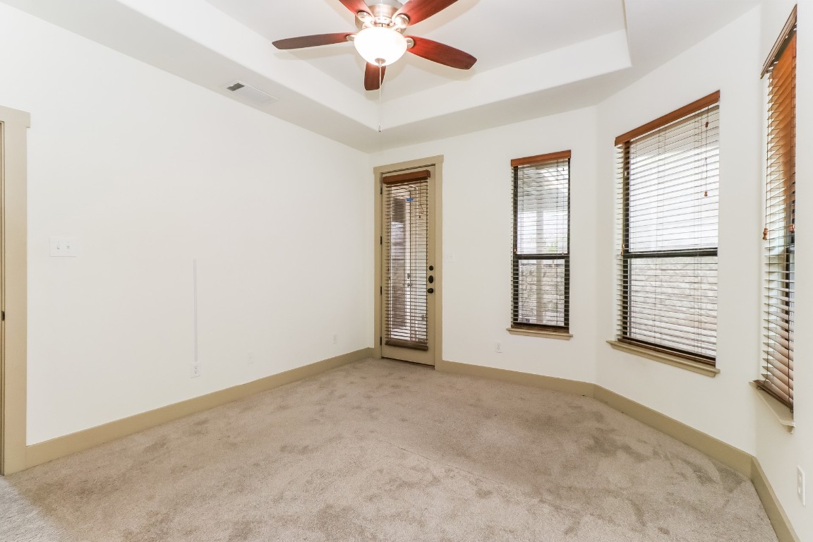 1212 Woodland Avenue, Unit A Austin, TX 78704 - Photo 9 of 20 an empty room with windows and fan
